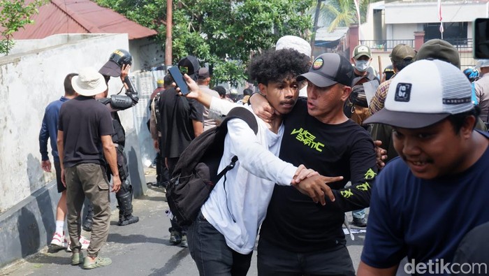 Polisi berpakaian preman mengamankan massa aksi di kantor DPRD Ternate yang berakhir ricuh, Senin (1/9/2025).