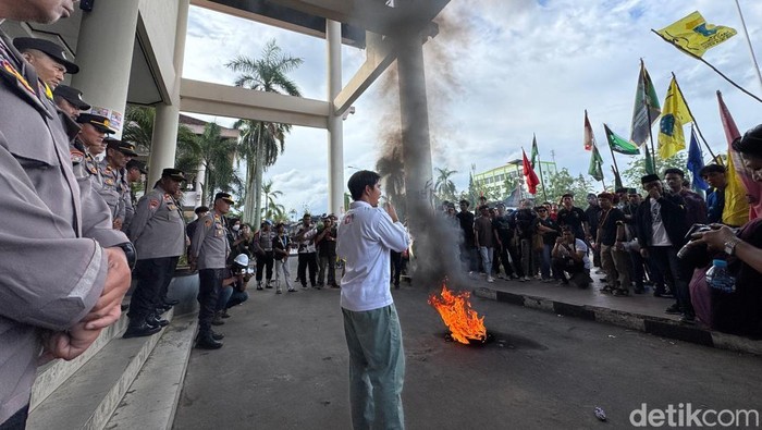 Mahasiswa peserta aksi membakar ban di depan kantor DPRD Kalbar.