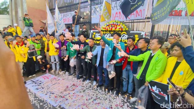 Aliansi BEM SI menggelar aksi damai di depan gedung DPR RI. Massa membagikan mawar hingga menaburkan bunga di depan pagar gedung DPR RI. (Kurniawan F/detikcom)