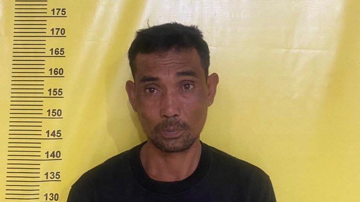 Tampang Andi (32) yang diduga membunuh rekan satu rumahnya, Ruswan (65) di Palembang.