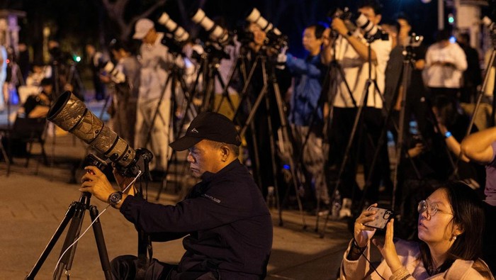 Photographers take images of the 