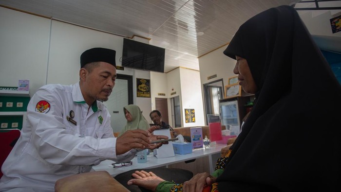 Petugas memindai sidik jari calon Jamaah Haji saat perekaman biometrik calon Jamaah Haji Kulon Progo dengan estimasi keberangkatan tahun 2026 di Kantor Kementerian Agama, Kulon Progo, D.I Yogyakarta, Senin (8/9/2025). Kantor Kementerian Agama Kulon Progo melakukan rekam biometrik calon Jamaah Haji 2026 hingga 15 September mendatang guna melengkapi dokumen administrasi penerbitan Visa serta Paspor Jamaah Haji 2026. ANTARA FOTO/Andreas Fitri Atmoko/rwa.