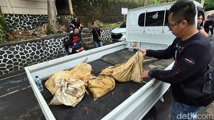 Salah seorang petugas membawa barang bukti berisi bahan tambang
