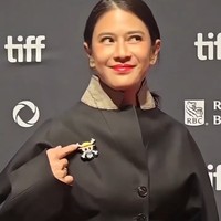 Saat berpose di depan kamera, aktris yang memilih tatanan rambut minimalis dengan gaya kuncir kuda ini terlihat berpose menunjuk pin yang dikenakannya. Foto: Instagram/@theraldisastr @greenlightpictures