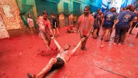 Selama satu jam, peserta saling melempar tomat matang. Akhirnya jalanan berubah penuh warna merah diiringi suasana semarak. Foto: AP/Reuters/Shutterstock