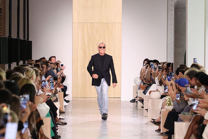 NEW YORK, NEW YORK - SEPTEMBER 11: Designer Michael Kors finale walks the runway during the Michael Kors Collection Spring/Summer 2026 Runway Show at Terminal Warehouse on September 11, 2025 in New York City.  (Photo by JP Yim/Getty Images for Michael Kors)