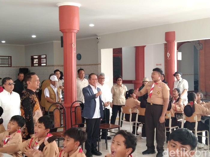 Menteri Lingkungan Hidup (LH), Hanif Faisol Nurofiq (pakai jas) saat mengunjungi SRMP 17 Tabanan di Sentra Mahatmiya, Desa Banjaranyar, Kecamatan Kediri, Tabanan, Sabtu (13/9/2025). (Krisna Pradipta)