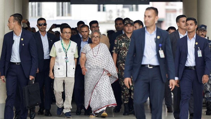 Newly sworn-in interim Prime Minister of Nepal, Sushila Karki, walks after meeting the victims of deadly anti-corruption protests at a hospital, in Kathmandu, Nepal, September 13, 2025. REUTERS/Navesh Chitrakar