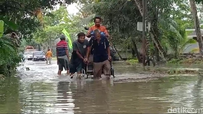 Sejumlah warga Pangandaran yang memanfaatkan banjir untuk nyari cuan