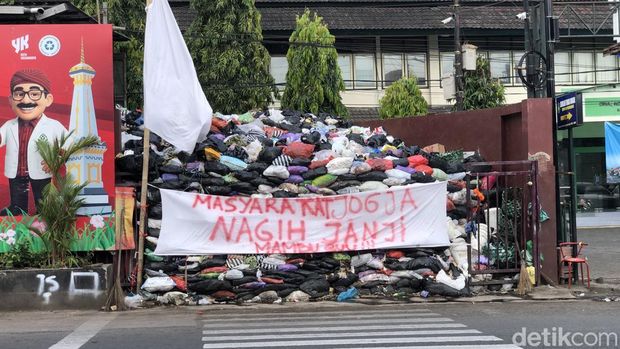 Spanduk 'Nagih Janji' di gunungan sampah depo Jalan Katamso, Jogja, Selasa (16/9/2025).