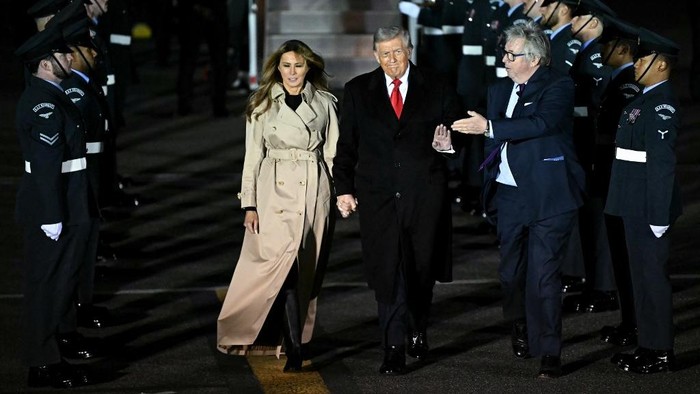 US President Donald Trump waves to members of the media alongside US First Lady Melania Trump after landing at Stansted Airport, eastern England, on September 16, 2025, on the first day of a two-day visit to the UK. US President Donald Trump arrived in the UK late Tuesday for a State Visit with his wife, Melania, a rare privilege made at the invitation of King Charles III. (Photo by Paul ELLIS / AFP)