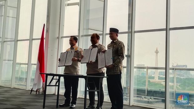 Kepala Badan Gizi Nasional (BGN) Dadan Hindayana bersama Menteri Pekerjaan Umum (PU) Dody Hanggodo, dan Menteri Dalam Negeri (Mendagri) Tito Karnavian melakukan penandatanganan Surat Keputusan Bersama (SKB) di Kantor BGN, Jakarta, Kamis (18/9/2025). (CNBC Indonesia/Martyasari Rizki)