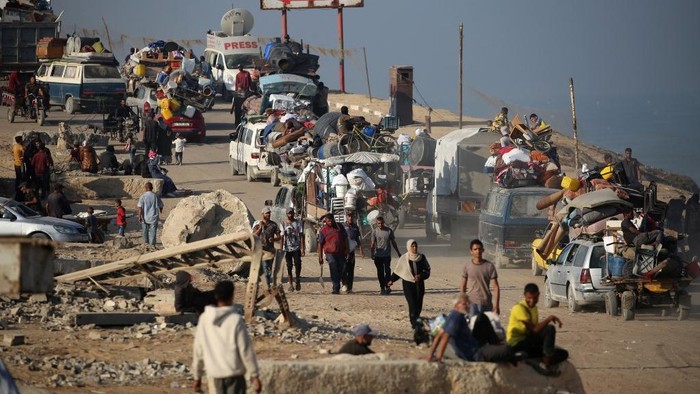 Displaced Palestinians move with their belongings southwards on a road in the Nuseirat refugee camp area in the central Gaza Strip following renewed Israeli evacuation orders for Gaza City on September 18, 2025. Israel has announced a major ground assault in Gaza City that it says is aimed at crushing Hamas in the Palestinian territorys largest urban hub. (Photo by Eyad BABA / AFP)