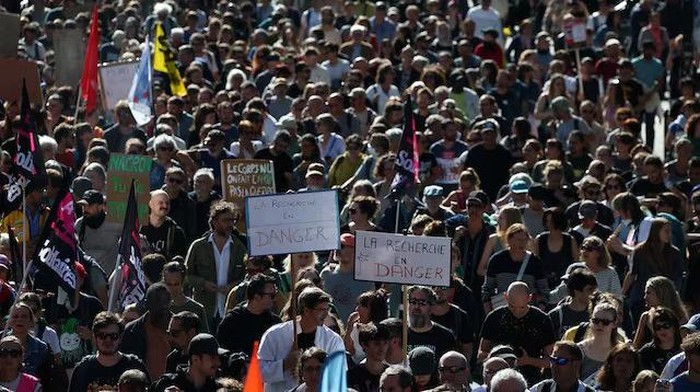 A general view shows protesters holding placards during a demonstration in Nantes as part of a day of nationwide strikes and protests against the government and cuts in the next budget, with supporters of the 