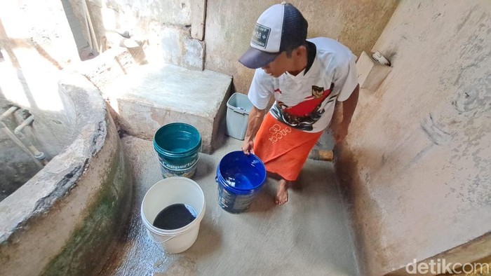 Warga menunjukkan kondisi sumur berwarna hitam yang diduga karena tercemar limbah dapur MBG di Kelurahan Mersi, Kecamatan Purwokerto Timur, Kabupaten Banyumas, Jumat (19/9/2025).