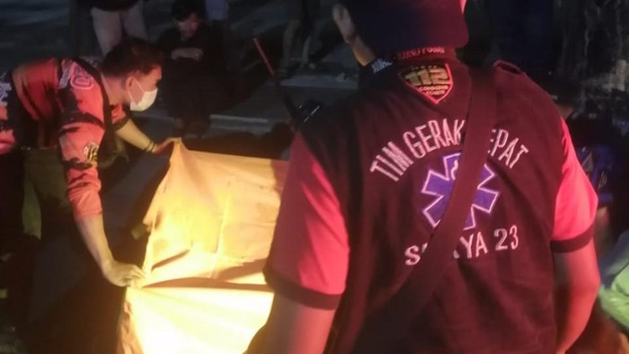 Saat petugas mengevakuasi 2 remaja yang meninggal akibat kecelakaan di Surabaya