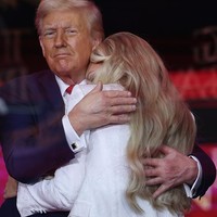 Haru biru tampak menyelimuti Erika yang menangis dalam pelukan Trump.  Foto: Getty Images/Joe Raedle