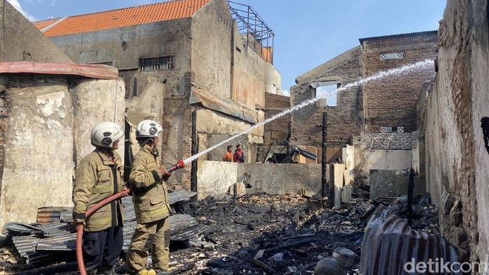 Damkar tengah melakukan pendinginan di rumah yang terbakar di Kampung Gang Inggris, Kelurahan Jagalan, Kecamatan Semarang Tengah, Kota Semarang, Sabtu (27/9/2025).