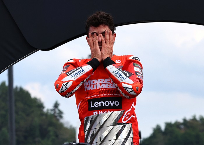 MotoGP - Japanese Grand Prix - Mobility Resort Motegi, Motegi, Japan - September 28, 2025 Ducati Lenovo Teams Marc Marquez celebrates on the podium with the trophy after winning the 2025 MotoGP World Championship REUTERS/Kim Kyung-Hoon