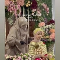 Adiba tampil cantik dengan pulasan riasan natural. Dekorasi acara pun tampak indah dengan dipenuhi bunga-bunga berwarna terang. Foto: Instagram/@_ummi_pipik_