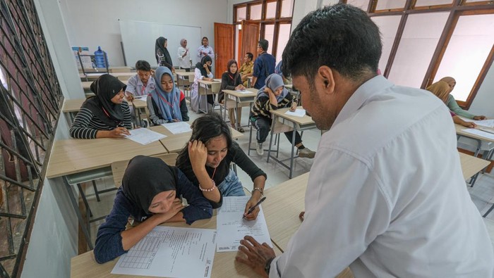 Guru mengarahkan siswi mengisi lembaran data diri saat Masa Pengenalan Lingkungan Sekolah (MPLS) di Sekolah Rakyat (SR) Terintegrasi 70 Dinas Sosial Sulawesi Tenggara di Kendari, Sulawesi Tenggara, Senin (29/9/2025). Sebanyak 100 siswa baru meliputi jenjang SMA sebanyak 50 orang dan SD sebanyak 50 orang mulai masuk asrama untuk mengikuti kegiatan pada hari pertama masa pengenalan lingkungan sekolah (MPLS) tahap 1C tahun ajaran 2025/2026. ANTARA FOTO/Andry Denisah/rwa.