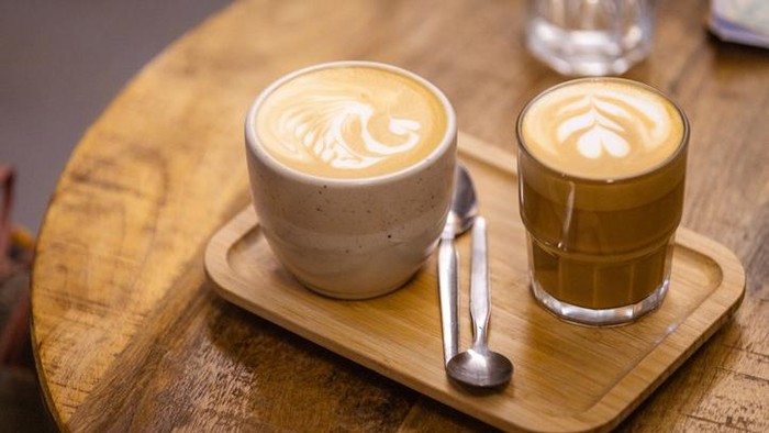 Two mugs of coffee are on the table.