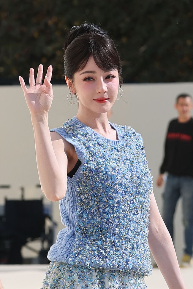 Dilraba Dilmurat menebarkan pesonanya saat datang ke fashion show Dior dalam balutan busana serba biru. Dilraba memadukan vest dan rok A-line berdetail sequin dengan sepatu high heels warna nude. Foto: Corbis via Getty Images/Stephane Cardinale