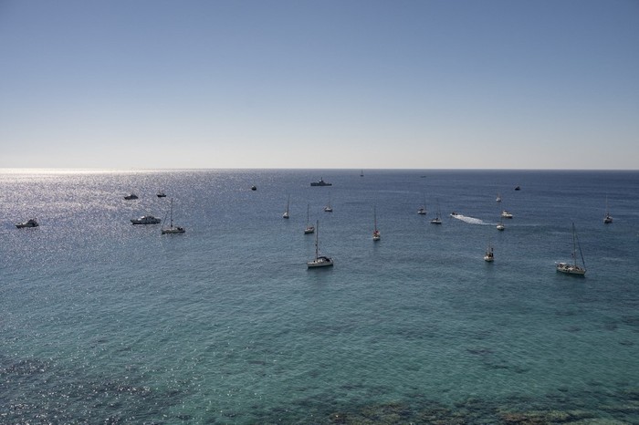 A group of ships of the Global Sumud Flotilla to Gaza are shown moored at the small island of Koufonisi, south of the island of Crete on September 26, 2025. After a reported attack by drones early on September 25, 2025 morning, Athens has said it will guarantee safe sailing in its waters. The Global Sumud Flotilla, carrying activists including Swedish environmentalist Greta Thunberg, blamed Israel for more than a dozen explosions heard around its vessels off Greece late on September 24, 2025. (Photo by Eleftherios ELIS / AFP)