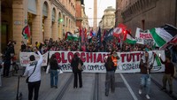 Demonstran pro-Palestina membawa bendera dan spanduk dalam aksi protes untuk mengecam intersepsi pasukan Israel terhadap beberapa kapal Armada Global Sumud yang bertujuan mencapai Gaza dan mematahkan blokade laut Israel, di Bologna, Italia, 2 Oktober 2025. Kapal-kapal GSF membawa obat-obatan dan makanan menuju Gaza. Foto: REUTERS/Michele Lapini