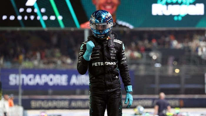 Formula One F1 - Singapore Grand Prix - Marina Bay Street Circuit, Singapore - October 4, 2025 Mercedes George Russell celebrates after qualifying in pole position REUTERS/Athit Perawongmetha