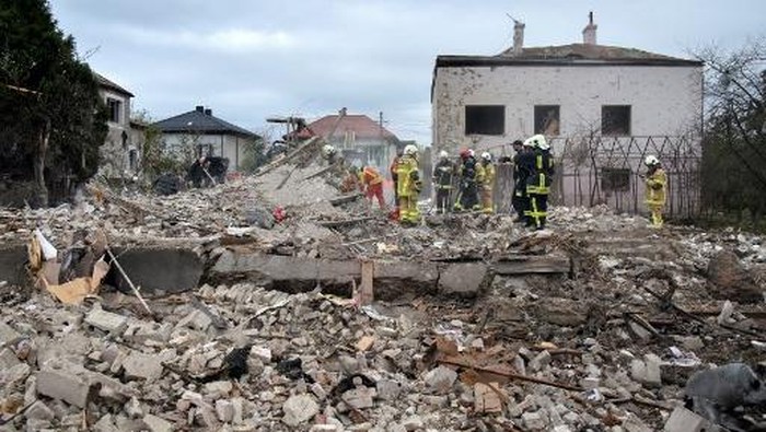 Ukrainian rescuers work among the rubble at the site of an air attack in Lapaivka, Lviv region on October 5, 2025, amid the Russian invasion of Ukraine. (Photo by AFP)