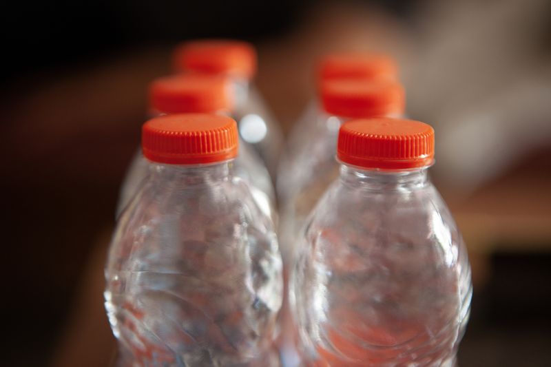 1484064446 close up of mineral water bottles, selective focus.