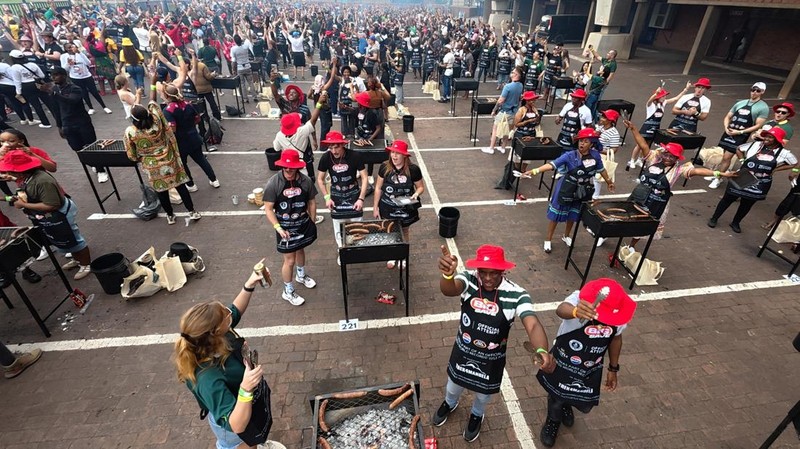People gather around braai stands as they attempt to break the Guinness World Record for the most people braaiing simultaneously at 'World's Biggest Braai' event on Heritage Day, at Loftus Versfeld Stadium, in Pretoria, South Africa, September 24, 2025. REUTERS/Siphiwe Sibeko