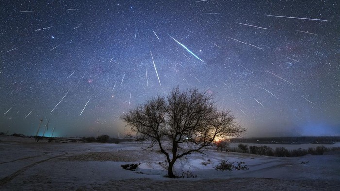 First place in the 2021 IAU OAE Astrophotography Contest, category Meteor showers: Geminid Meteor Shower from China, by Dai Jianfeng, China. A meteor shower occurs when the Earth in its orbit around the Sun, passes through a debris trail left previously by a comet on its approach around the Sun. As the Earth enters this debris (small sand grain sized), they enter the atmosphere at high speeds and on parallel trajectories, burning completely leaving beautiful tracks (streaks) in the sky. These streaks can appear and disappear in the blink of an eye, or last much longer. On rare occasions the debris originates from asteroids, as in the case of the Geminid meteor shower, shown in this image, picturing many streaks of debris captured in the sky of China in 2017. Due to relative motions and perspective, the shower appears to come from one single point, known as the radiant point, beautifully pictured in this image. This is similar to driving in a car on a rainy day without any wind, looking out the front window it seems that the rain is coming directly towards the window, when in fact the rain is falling vertically downwards. Link:  See image in Zenodo