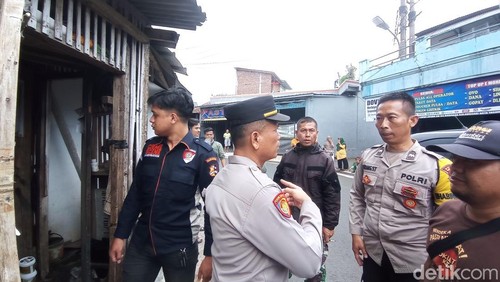 Polisi saat mengamankan lokasi penggerebekan kakek cabul sesama jenis.