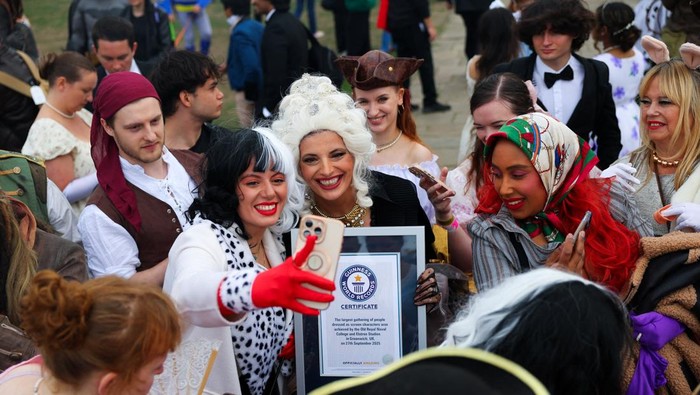 Cosplayers pose for a group photo after breaking the Guinness World Record for the largest gathering of people dressed as screen characters, at the Old Royal Naval College in London, Britain, September 27, 2025. REUTERS/Isabel Infantes