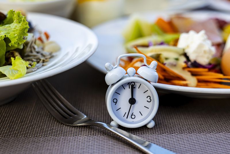 Alarm clock with IF (Intermittent Fasting) 16 and 8 diet rule and weight loss concept.-Diet plan concept