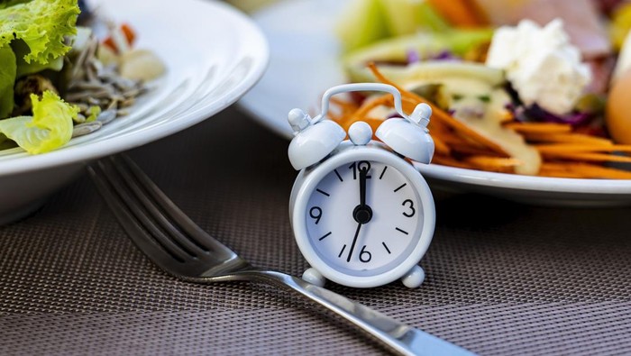 Alarm clock with IF (Intermittent Fasting) 16 and 8 diet rule and weight loss concept.-Diet plan concept