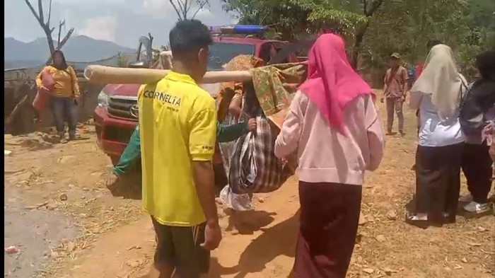 Seorang wanita yang hendak bersalin ditandu sejauh 7 km menuju ambulan karena jalan rusak.