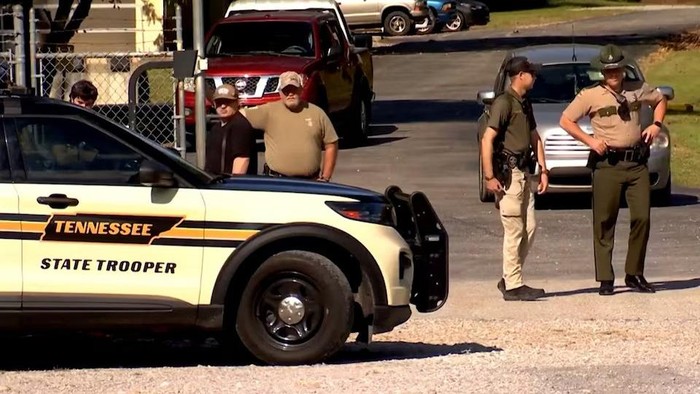 Law enforcement officers guard a gate outside the Accurate Energetic Systems military explosives plant, after an explosion at the facility in Bucksnort, Tennessee, U.S. October 10, 2025 in a still image from video. ABC Affiliate WKRN via REUTERS. Purchase Licensing Rights