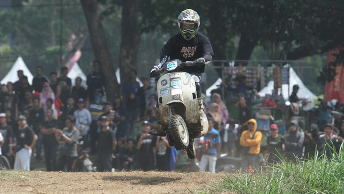 Seorang peserta memacu kecepatan skuternya saat mengikuti Scooter Fun Cross di GOR Jayabaya, Kota Kediri, Jawa Timur, Minggu (12/10/2025). Balap skuter modifikasi offroad pada Kediri Scooter Festival #8 tersebut menjadi ajang silaturahmi ribuan pecinta skuter Vespa dari berbagai daerah se-Indonesia. ANTARA FOTO/Prasetia Fauzani/tom.