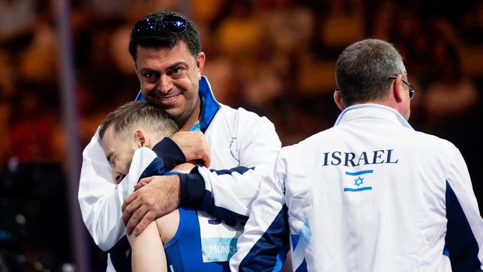 MUNICH, GERMANY - AUGUST 21: Artem Dolgopyat of Israel is hugged by his coach during the Artistic Gymnastics competition on day 11 of the European Championships Munich 2022 at Olympiapark on August 21, 2022 in Munich, Germany. (Photo by Mateusz Slodkowski/DeFodi Images via Getty Images)