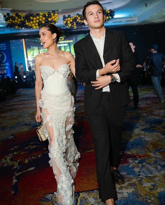 Cinta datang ditemani sang kekasih, Arya Vasco, yang tampil klasik dalam setelan jas hitam. Foto: Instagram/@claurakiehl