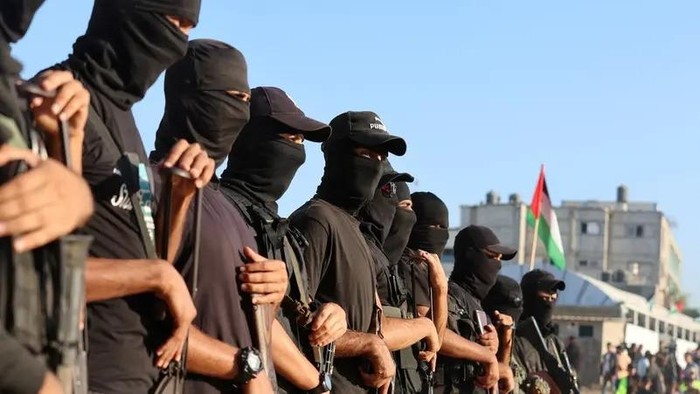Palestinian militants stand guard in Khan Younis, southern Gaza Strip, October 13, 2025. (Reuters)