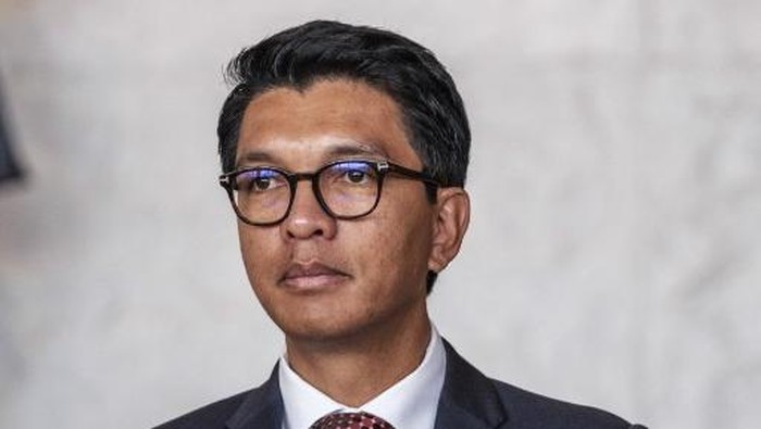 (FILES) President of Madagascar Andry Rajoelina arrives for an official dinner at the Elysee Palace, on the sidelines of the New Global Financial Pact Summit, in Paris, on June 22, 2023. Madagascars lower house of parliament voted on October 14, 2025 to impeach President Andry Rajoelina for desertion of duty, in a session dismissed by the presidency as devoid of any legal basis. 
The resolution passed with 130 votes in favour, well above the two-thirds constitutional threshold required in the 163-member chamber, marking a forceful rebuke of the leader who has gone into hiding after weeks of street demonstrations over the island nations governance. (Photo by Ludovic MARIN / AFP)