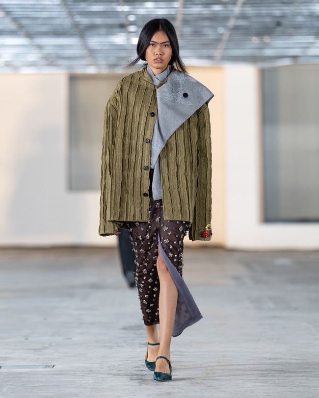 apto membuka kembali arsip lamanya dan menafsirkannya dengan sentuhan baru. Motif kotak-kotak yang dulu muncul sebagai kain jadi kini hadir dalam bentuk bordir tiga dimensi menyerupai anyaman, sementara motif buah mengkudu, simbol penyembuhan dalam tradisi Nusantara, tampil berdampingan dengan bordir yayi-turangan bergambar kuda dan ombak. (Foto: Dok. Sapto Djojokartiko)