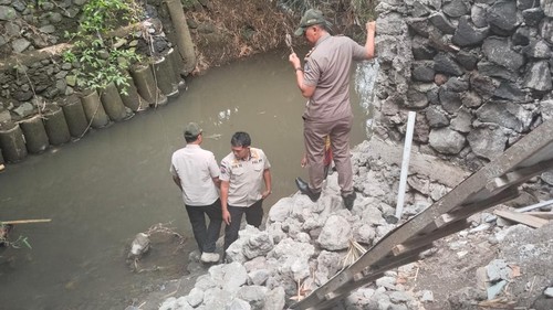 Satpol PP Badung melihat pembongkaran bangunan pondasi tanggul yang mepet aliran sungai di Batu Belah, Desa Pererenan, Kecamatan Mengwi. (Dok Satpol PP Badung)