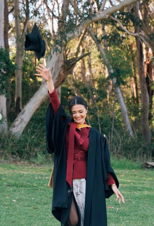 Amanda menata rambutnya dalam sanggul rendah rapi dengan helaian poni tipis di sisi wajah. Gaya rambut ini memberikan sentuhan klasik dan feminin namun tetap profesional. Foto: Instagram/@amandarawles