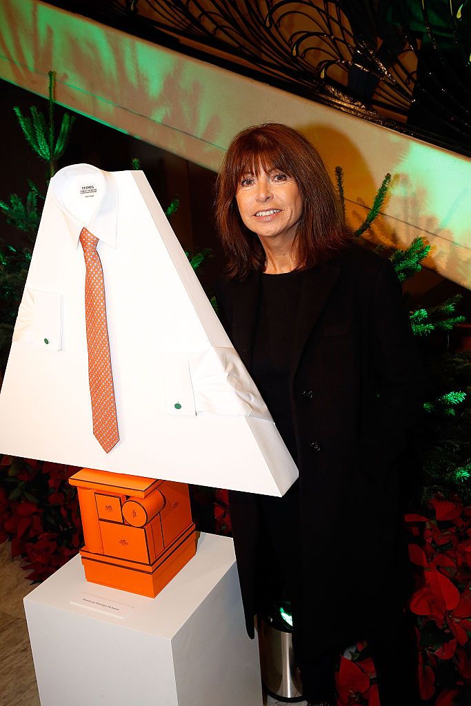 PARIS, FRANCE - NOVEMBER 20:  Veronique Nichanian poses with Hermes Christmas tree during the 20th Edition of 'Les Sapins de Noel des Createurs - Designer's Christmas Trees press preview held at Theatre des Champs Elysees on November 20, 2015 in Paris, France.  (Photo by Bertrand Rindoff Petroff/Getty Images)