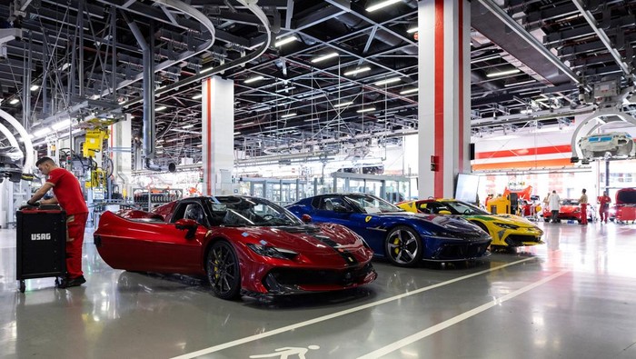 A Ferrari technician works next to assembled Ferrari cars inside the company's factory in Maranello, Italy, October 2, 2025. REUTERS/Remo Casilli